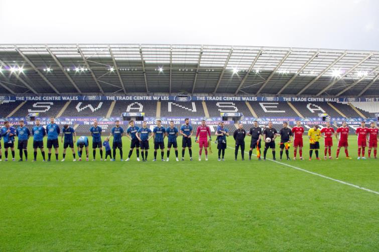 Both teams line up before kick off